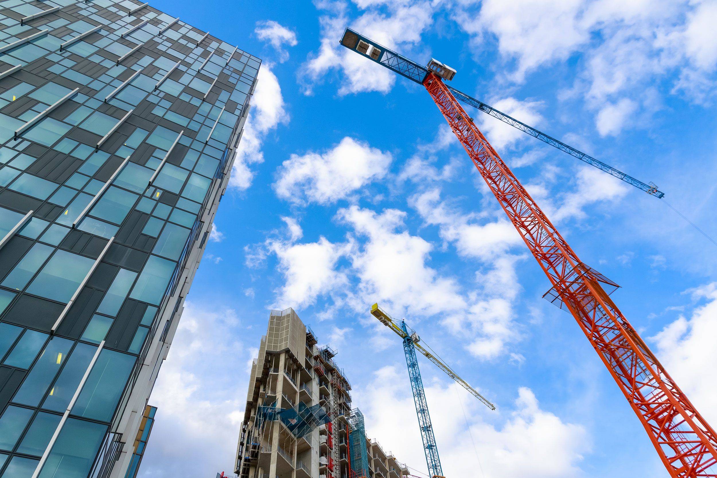 Tall tower crane on a construction site.